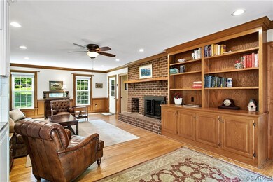 Notice the wide built-in bookshelves and fireplace