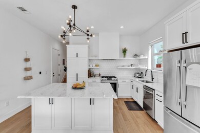 Kitchen featuring a sink, visible vents, extracto