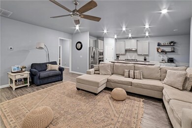 Living room featuring wood finished floors and ceiling fan