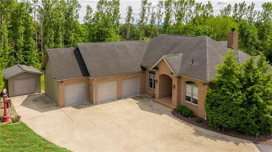 FRONT DOOR, 3 CAR ATTACHED GARAGE AND 12 X 16 UTIL