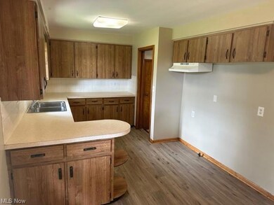 Kitchen featuring light hardwood flooring, light c