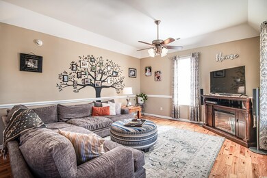 Living room featuring ceiling fan, hardwood / wood