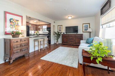 Living room with ornamental molding and dark wood-