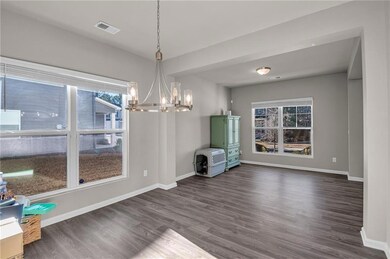 Unfurnished dining area featuring dark wood-type f