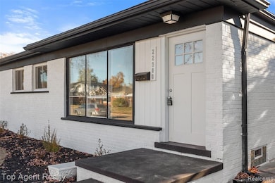 Property entrance featuring brick siding