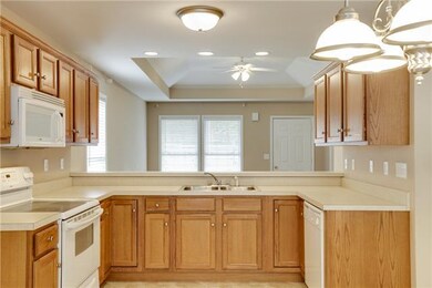 Spacious Kitchen with Oak Cabinets, White applianc