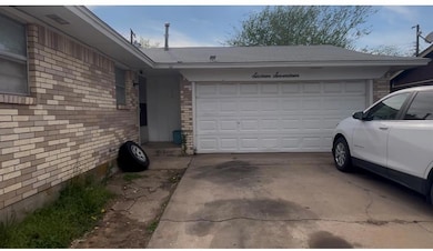 Garage featuring driveway