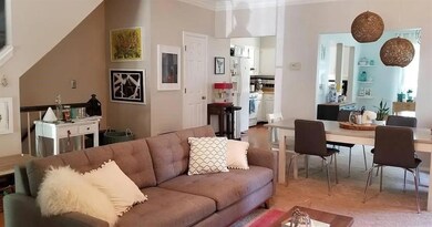 Living area featuring light colored carpet