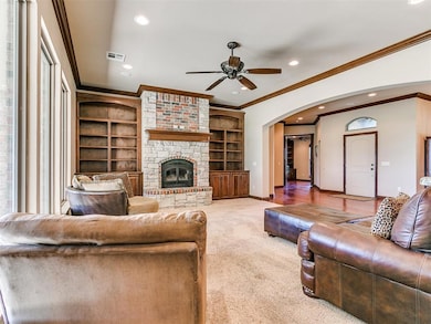 Living room with ornamental molding, ceiling fan, 