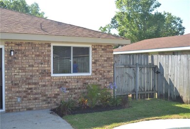 Rear yard landscaped with gate for access.