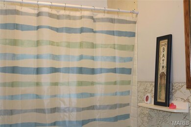 Bathroom featuring a shower with curtain