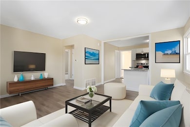 Virtual Staging Living area featuring light wood-style flooring and baseboards