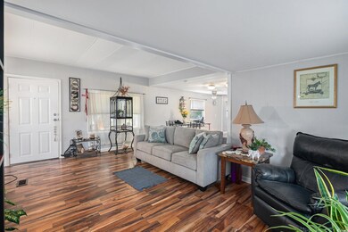 Living area featuring dark wood-style flooring and wooden walls