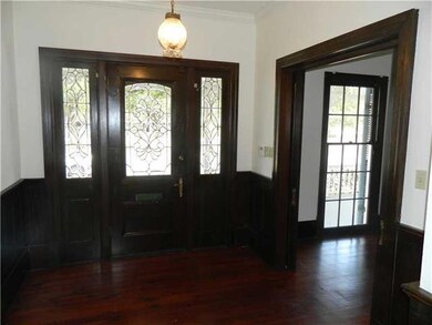 Foyer. The leaded glass door and side lights lead