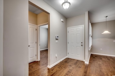 Foyer entrance featuring hardwood / wood-style flo