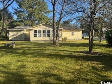 Back of property featuring a yard