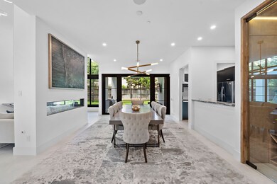 A dual-sided fireplace sits between the formal din
