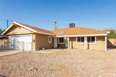 Ranch-style house with an attached garage, cooling