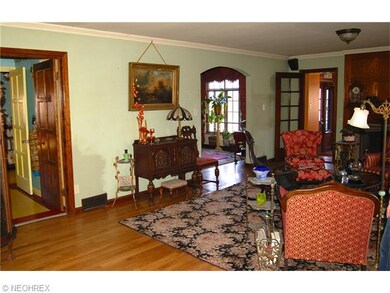 Entry to kitchen and rear hall (also half bath) to the left of photo, arched entry to DR to the right above
