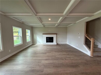 Unfurnished living room featuring beamed ceiling, 