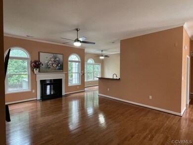 Unfurnished living room with ornamental molding, c