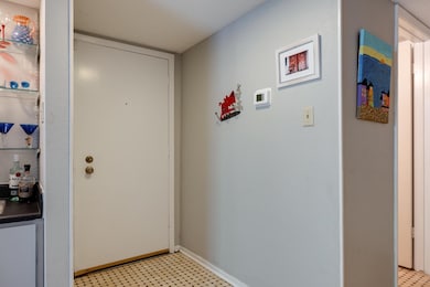 Entryway with light floors and baseboards