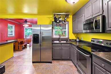 Open kitchen with stainless appliances and dining area