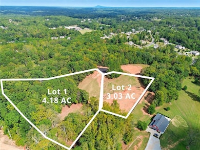 Aerial view of property and surrounding area with property parcel outlined