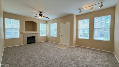 Unfurnished living room with a ceiling fan, carpet