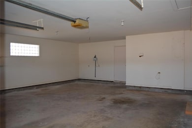 Garage with electric panel and a garage door opener