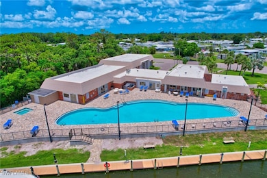 Community pool with a fenced backyard and a patio