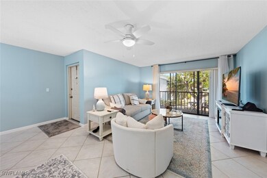 Living room featuring baseboards, a ceiling fan, a
