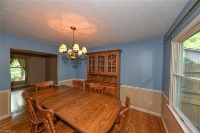 Formal dining room with hardwood floors, large win