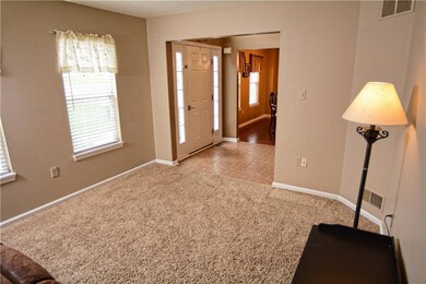 The bright and versatile living room is privately 