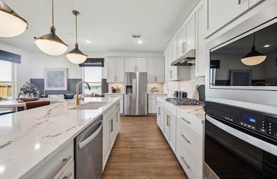 Spacious eat-in kitchen designed with a large island for dining *Model representation
