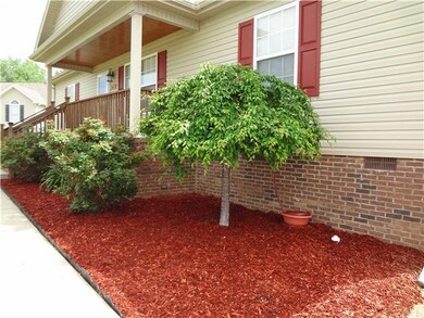 What a great looking (low maintenance) flower bed. Also, notice the Bead Board Ceiling of the porch. 