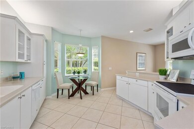 Kitchen with hanging light fixtures, white applian