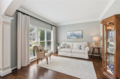 Living room or office space with hardwood floors and crown molding