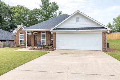 View of front of house with brick siding, a shingled roof, driveway, and an attached garage