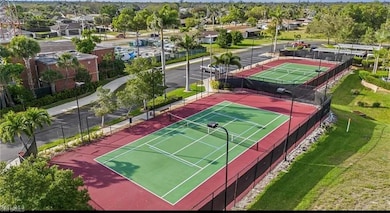 View of sport court with fence and a residential v