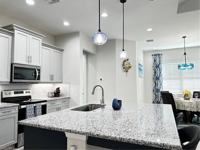 Kitchen featuring stove, sink, an island with sink