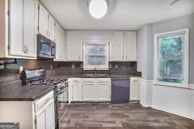 Kitchen featuring white cabinets