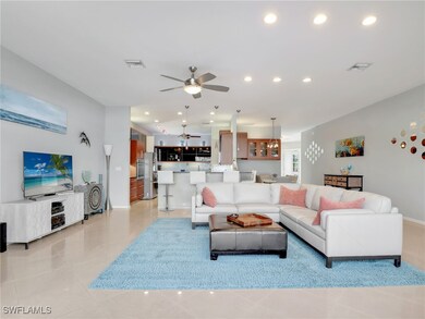 Living room with light tile patterned floors and c
