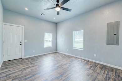 Unfurnished room featuring visible vents, wood fin