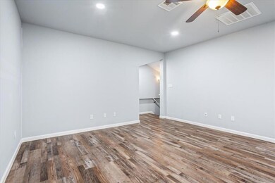 Spare room featuring a ceiling fan, wood finished