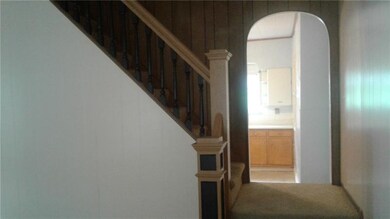 The stairwell separates the kitchen and living are