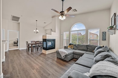 Open great room with vaulted ceilings, lots of natural light, picture windows, luxury vinyl plank flooring.