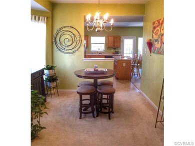 Open dining room with chandelier and bay window