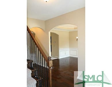 Foyer. Hardwood flooring in foyer, wrought iron pi
