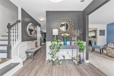 Entryway featuring stairway and wood finished floors